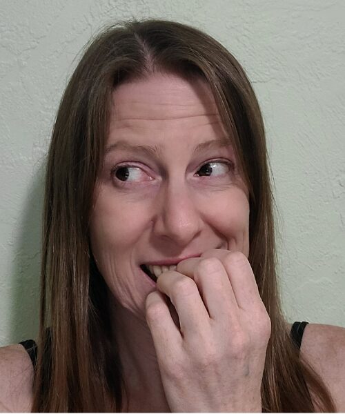 A woman looking off to the left, with a nervous expression