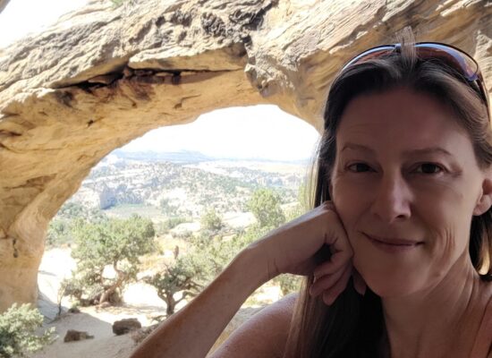 Amber sits beneath Moonshine Arch in Vernal, UT